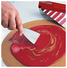 Inks being mixed using the PANTONE® formula guide
